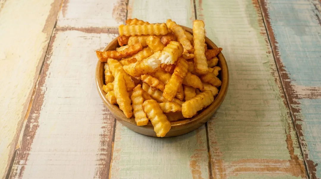 Golden crispy french fries fried in beef tallow with fluffy interior texture