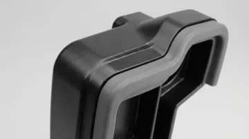 Multi-material injection molded automotive interior components showing dual-shot construction
