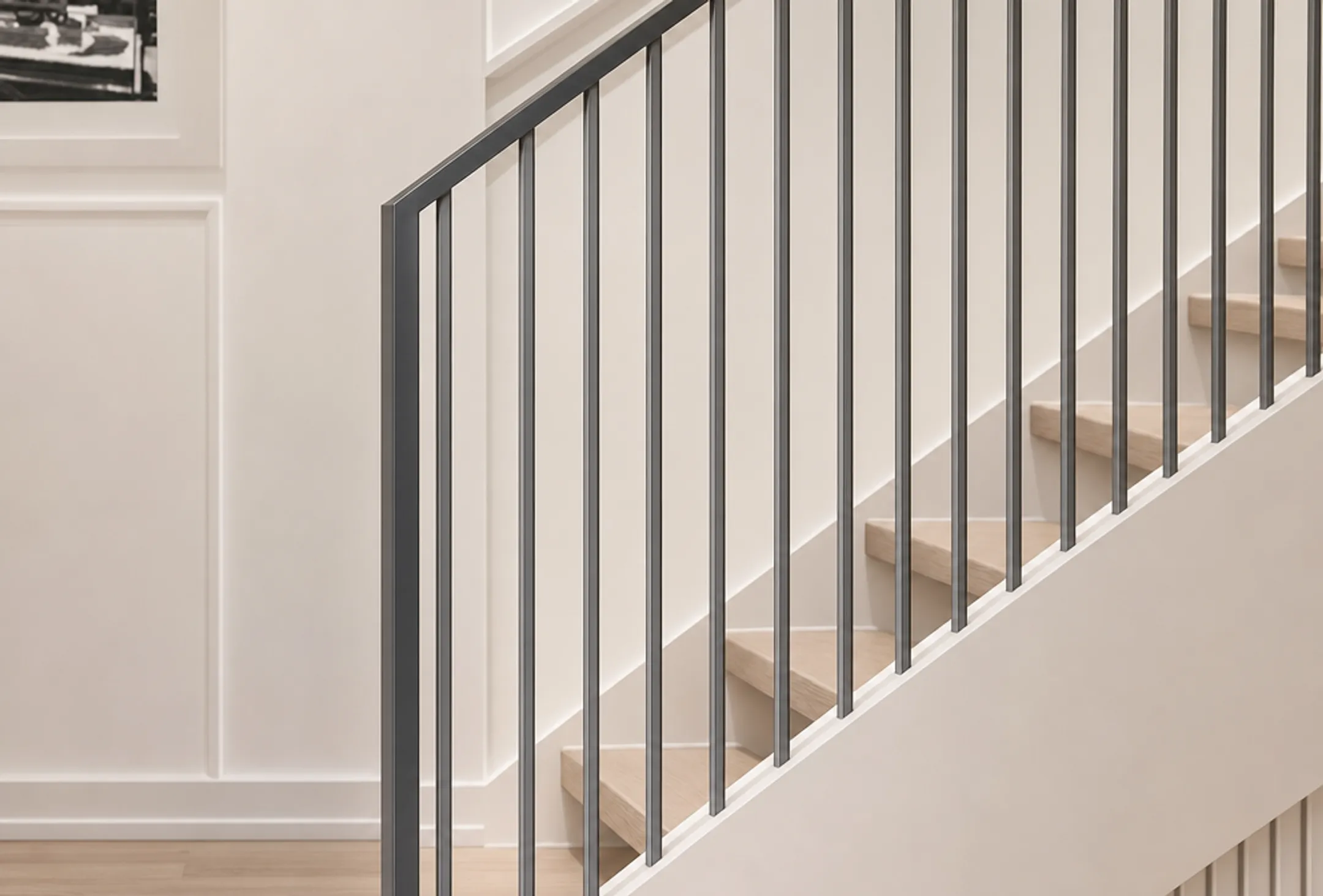 Modern staircase with powder-coated metal balusters and custom handrail