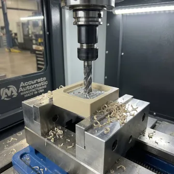 CNC machinist precision-machining a PEEK plastic component on a CNC milling machine