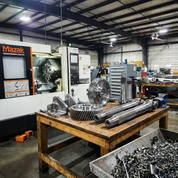 CNC machining precision agricultural equipment parts in a manufacturing facility