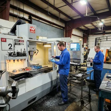 Precision CNC machining shop floor with active CNC milling and turning equipment