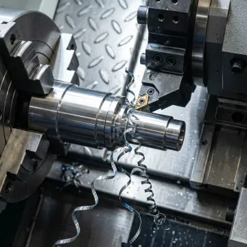 CNC turning machine producing precision metal parts in an Illinois machine shop