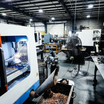 Precision CNC milling machine cutting a metal part in a professional machine shop