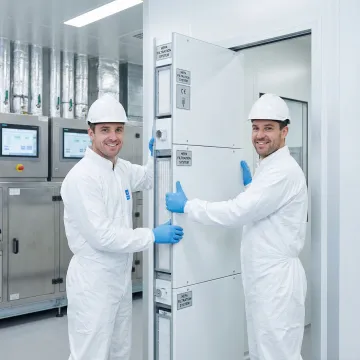 Modular cleanroom components being assembled in controlled environment