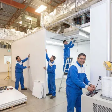 Technicians installing modular cleanroom components