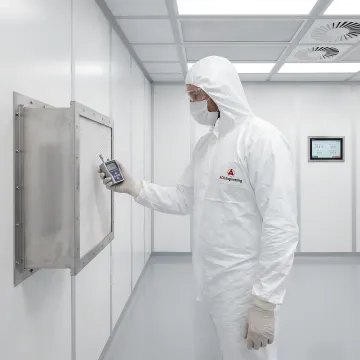 Cleanroom technician performing maintenance and inspection on HEPA filtration system in controlled environment