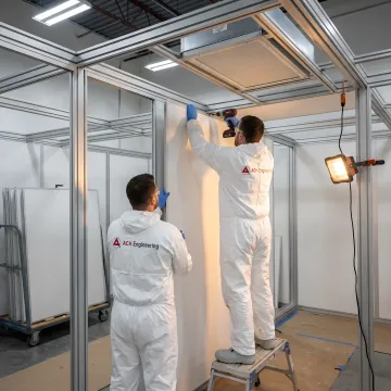 Modular cleanroom components being assembled in controlled environment