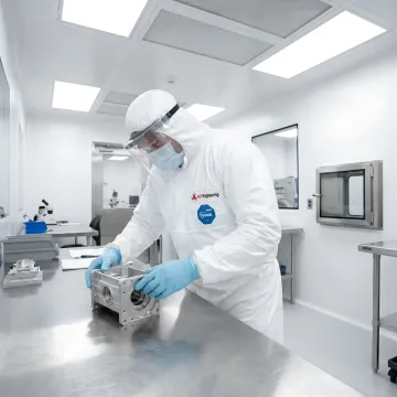 Aerospace technician working in controlled cleanroom environment