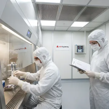 University researchers working in a custom-built modular cleanroom environment