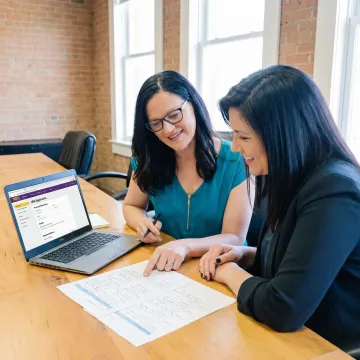 Professional mentor reviewing a recommendation letter brief with an MBA applicant