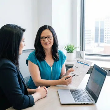 MBA consultant providing structured feedback to a candidate after a mock interview session