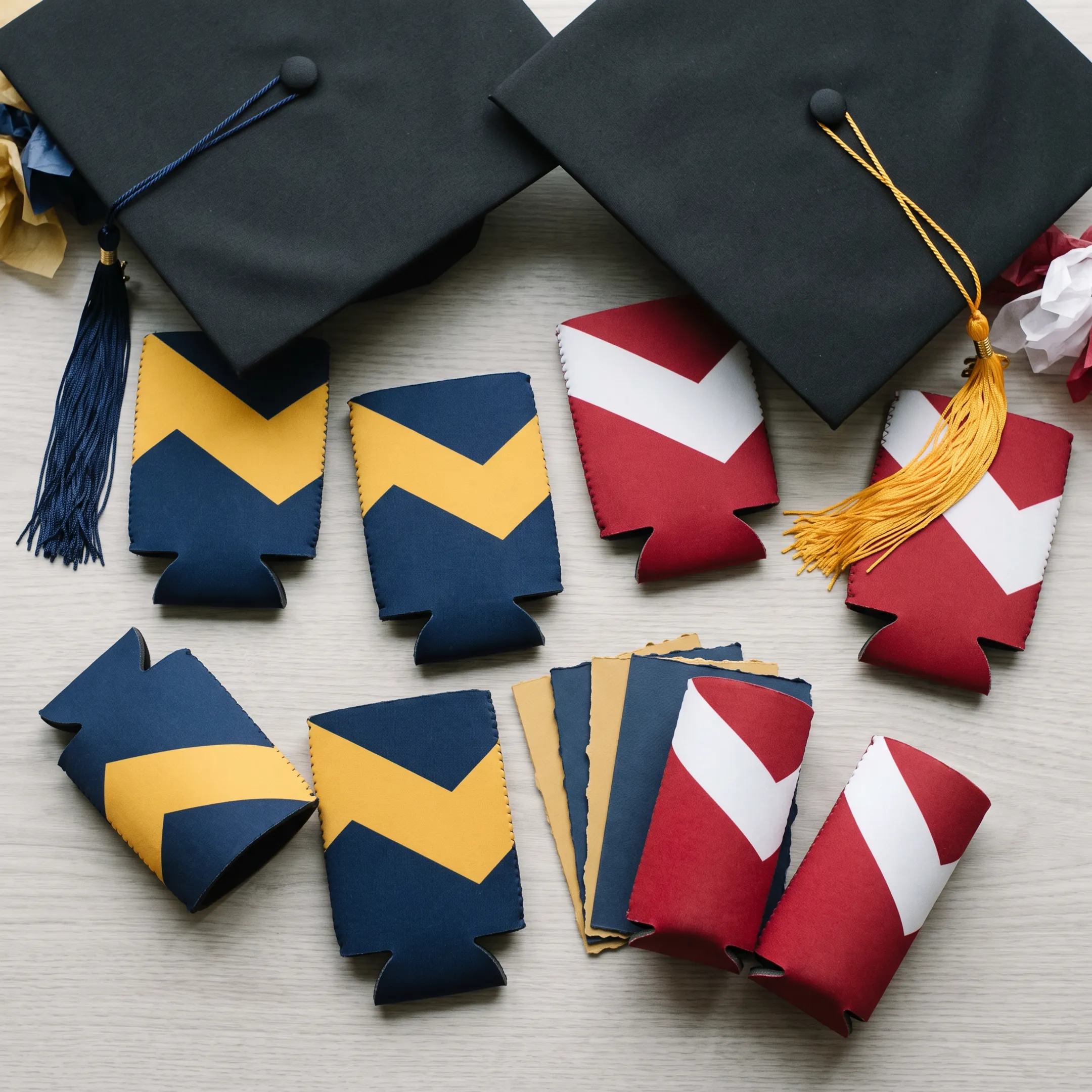 Custom graduation koozies and can coolers arranged for a celebration