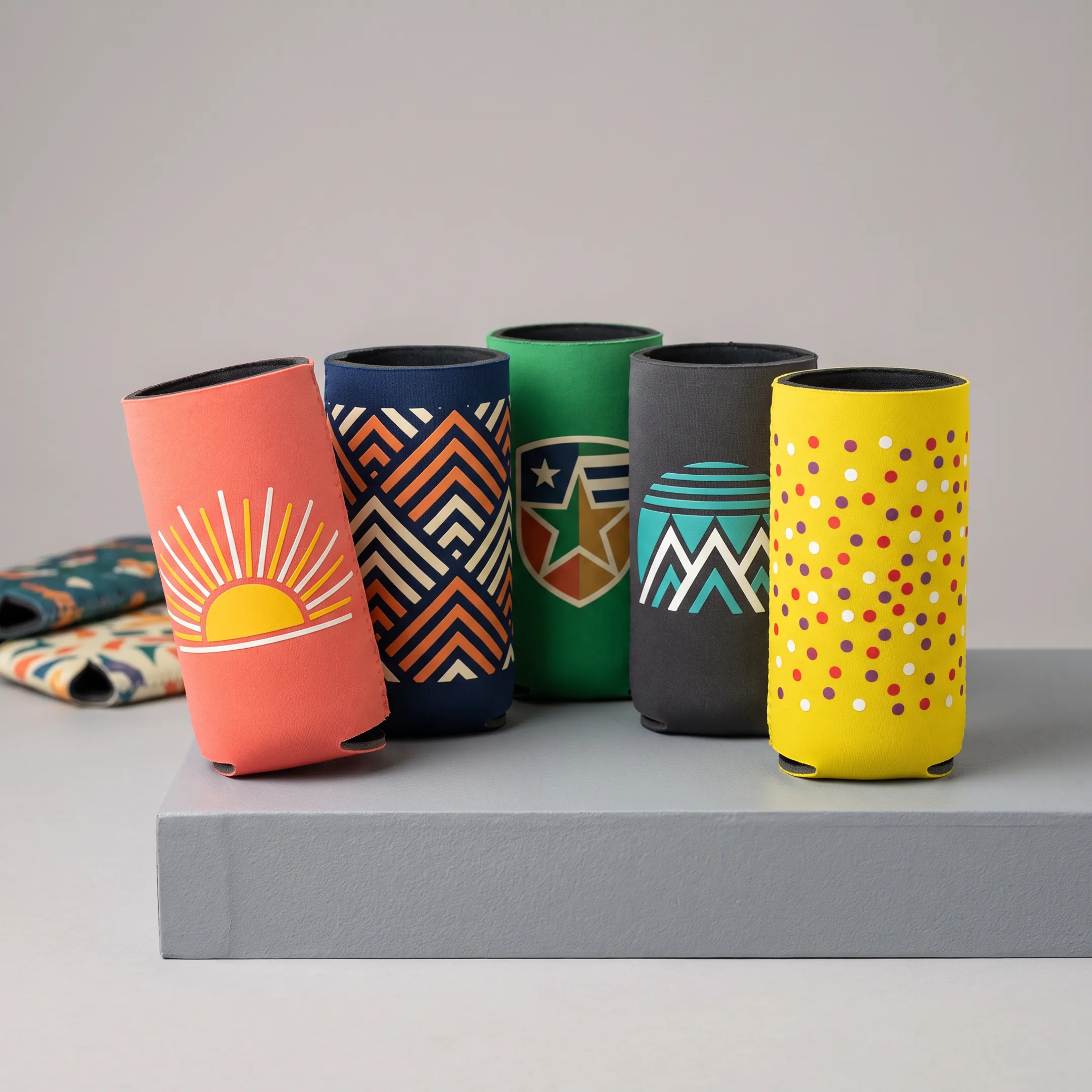 Close-up of custom printed can coolers featuring colorful branded artwork