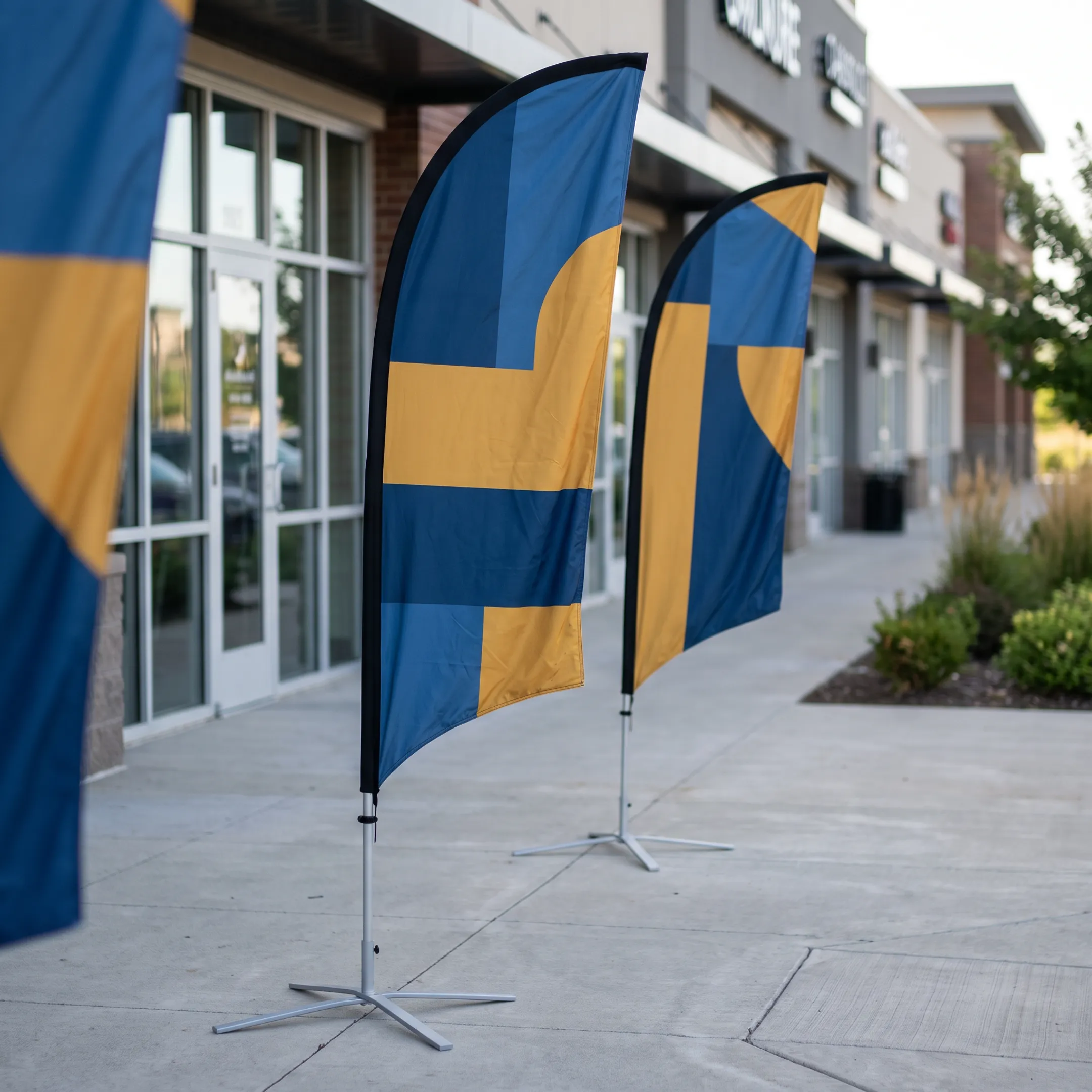 Printed feather flags showing business branding outside a commercial location