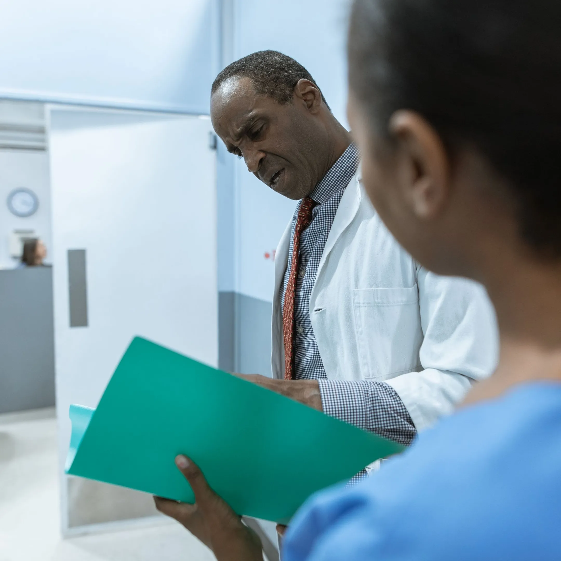 Healthcare professional reviewing a summarized medical record on screen
