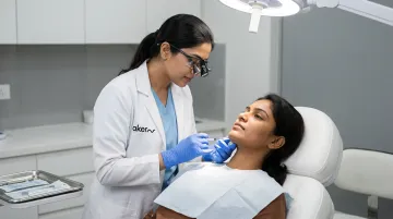 Medical professional administering dermal filler injection to patient jawline area