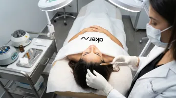 Dermatologist performing PRP plasma hair restoration session on patient scalp