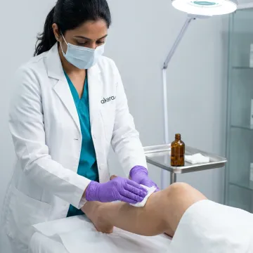 Dermatologist applying chemical peel to knee