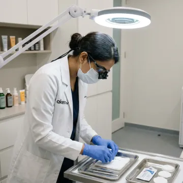Doctor preparing sterile tools for milia removal