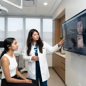 Dermatologist explaining cosmetic skin treatment options
