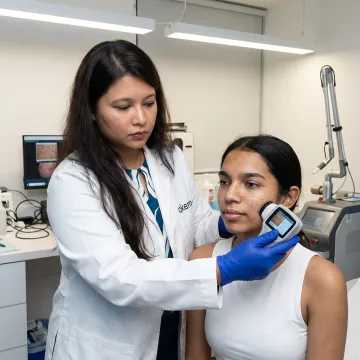 Dermatologist assessing freckles before laser treatment