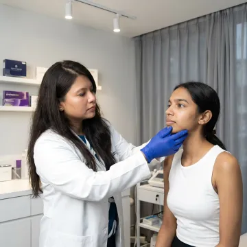 Dermatologist assessing jawline filler needs