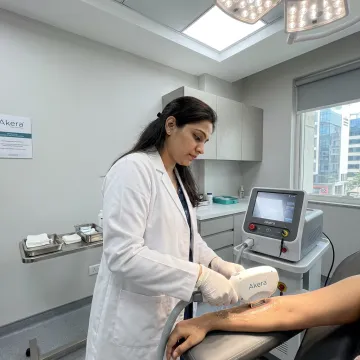 Dermatologist performing laser hair removal treatment