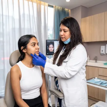 Dermatologist consulting patient before chin filler treatment
