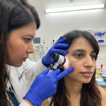 Dermatologist assessing facial pigmentation