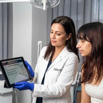 Dermatologist discussing lip filler pricing with patient
