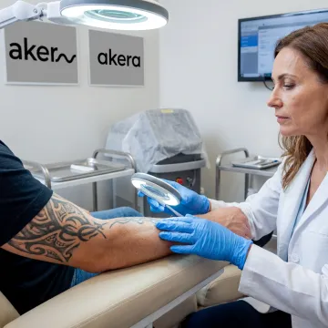 Dermatologist assessing tattoo before laser removal
