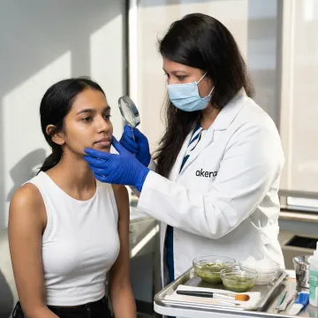 Dermatologist reviewing skin before peel treatment