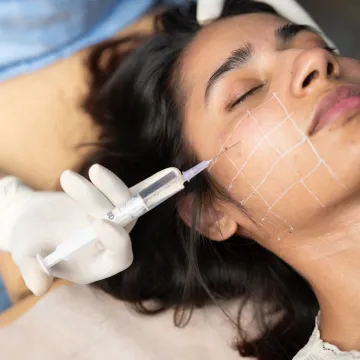 Clinician assessing cheek filler treatment plan
