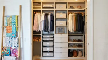 Organized closet system with labeled storage and color-coded hanging clothes