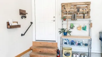 Organized garage with labeled bins and pallet style tool storage wall