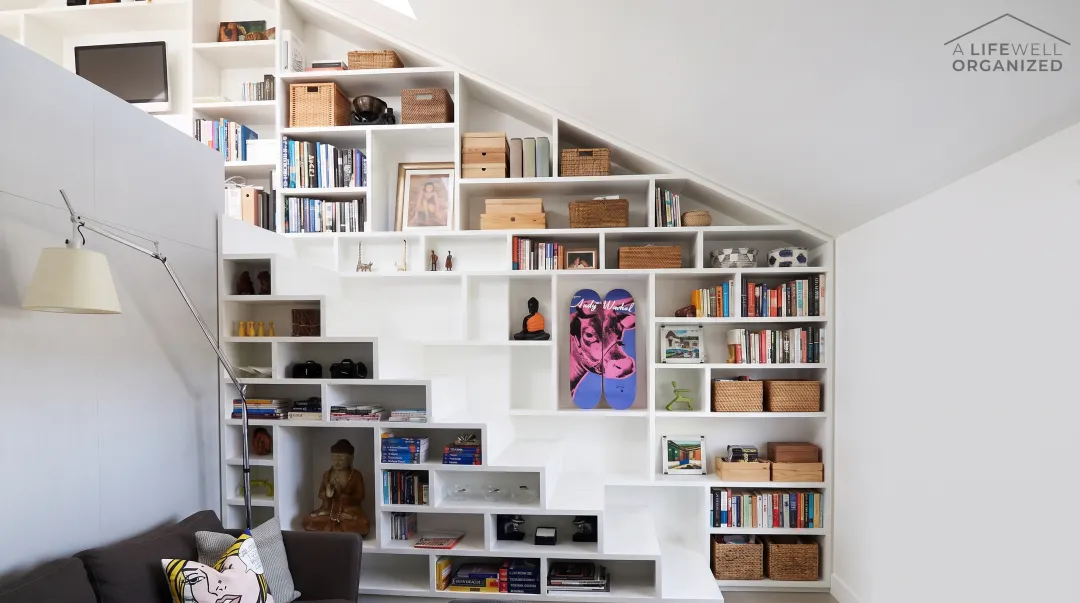 Floor-to-ceiling shelving system maximizing vertical storage space in compact urban apartment