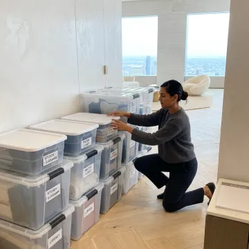 Luxury moving concierge organizing boxes in a new home