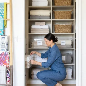 Organizer labeling storage bins in a home closet