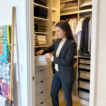 Professional organizer arranging labeled home storage
