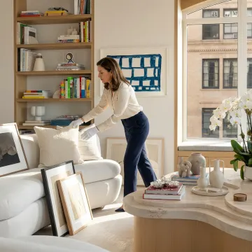Organizer styling a living room for real estate listing photos
