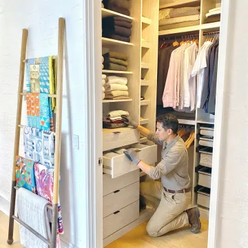 Professional organizer arranging a luxury home closet