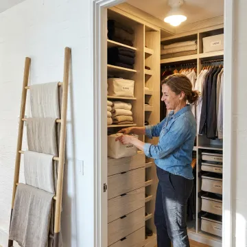 Professional organizer arranging labeled storage bins
