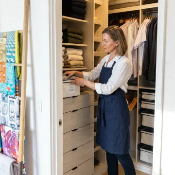 Luxury home organizer arranging storage bins
