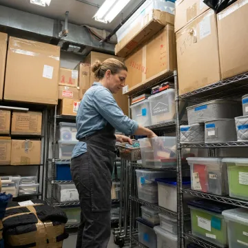 Professional organizer arranging labeled storage bins