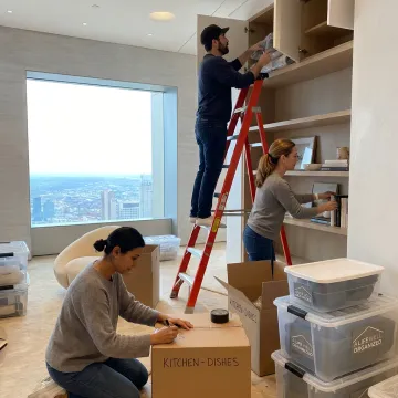 Organizers labeling boxes during a luxury move