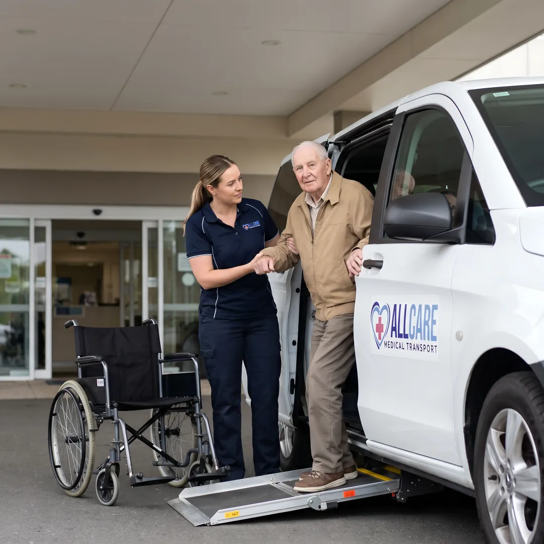 Medical transport specialist helping dialysis patient into wheelchair-accessible vehicle