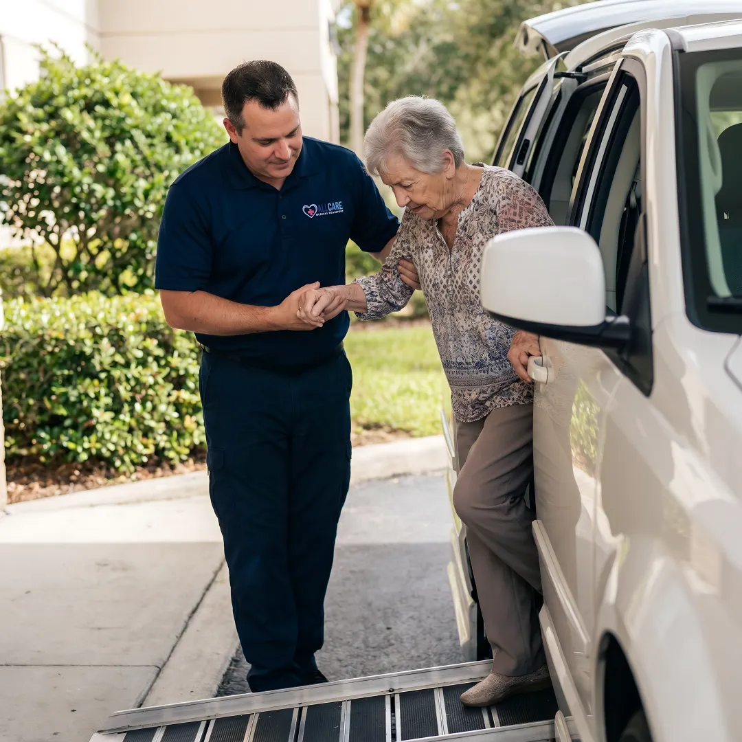Medical transport specialist assisting senior patient into wheelchair van