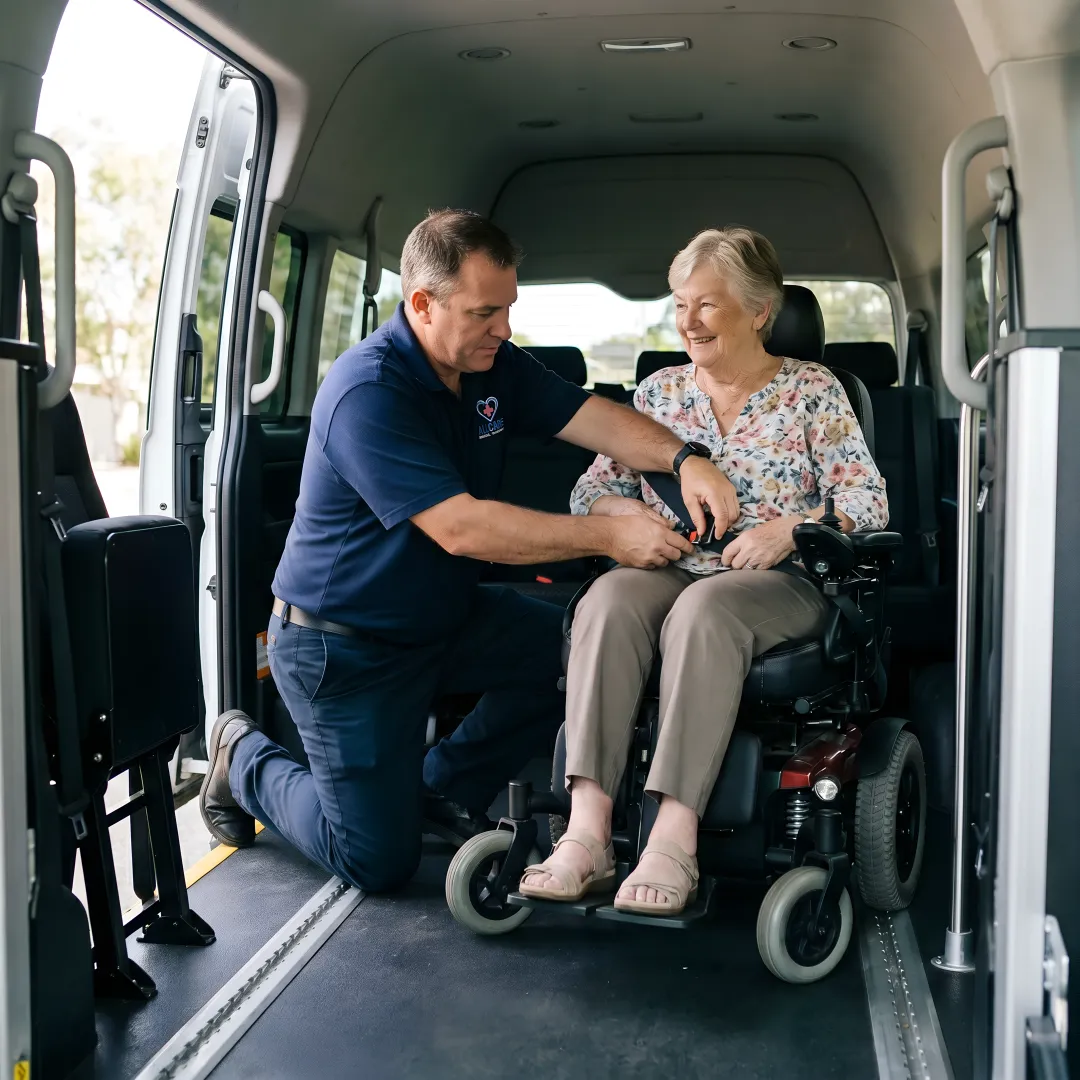 Medical transport specialist securing elderly passenger in wheelchair-accessible vehicle
