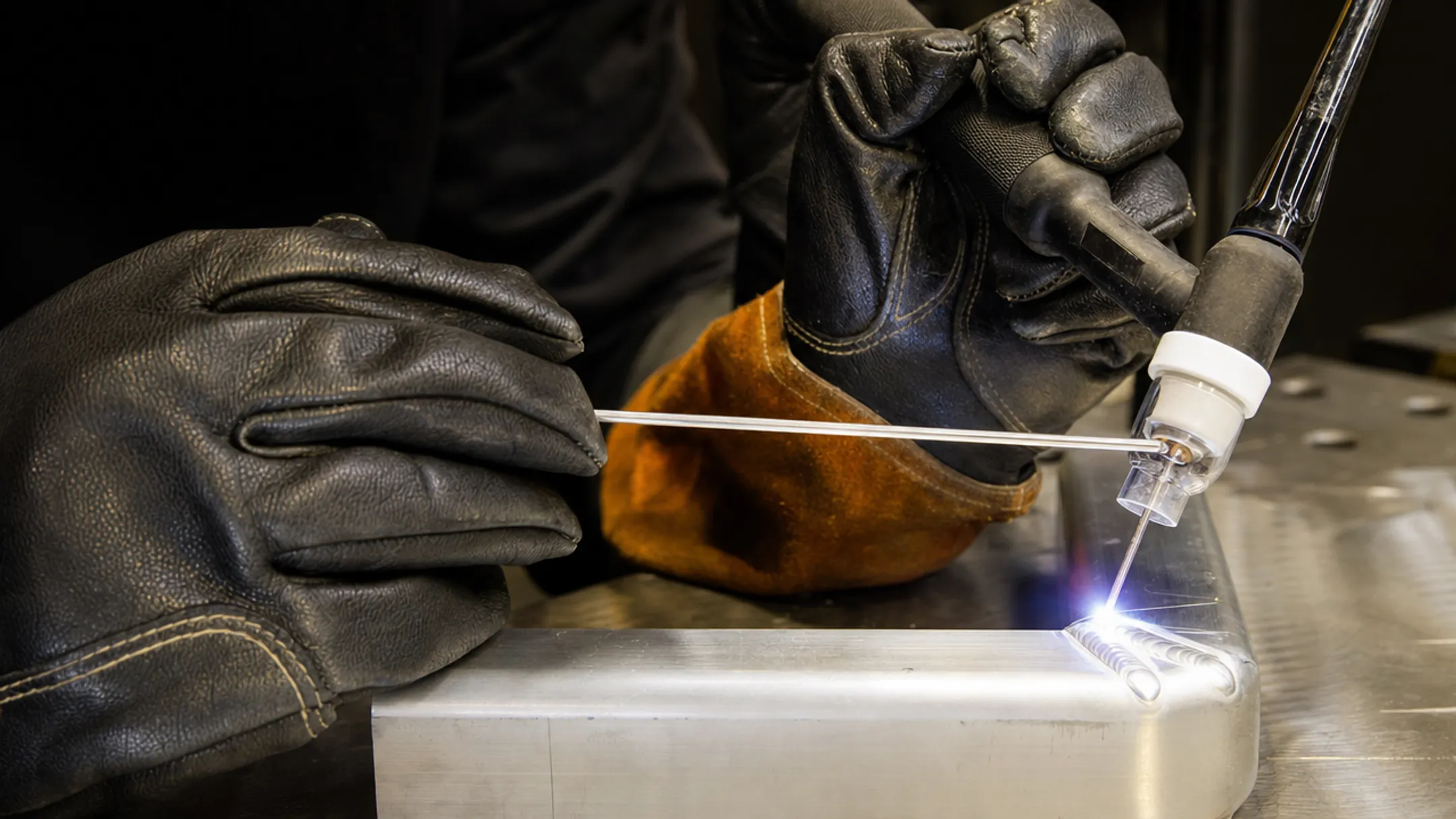 TIG welder controlling arc on nickel alloy metal workpiece